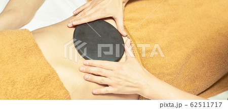body stone massage. Hot rock masseur. Girl at 62511717