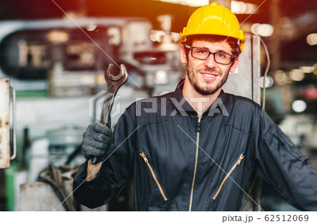 Happy worker nerdy glasses working in industry factory hand with wrench wear safety Happy worker nerdy glasses working in industry factory hand with wrench wear safety 62512069