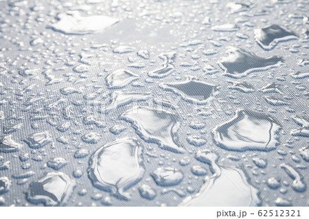 Water drops are on a white plastic fabric. Water drops are on a white plastic fabric. 62512321