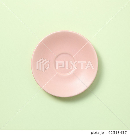 Pink ceramic dish isolated on green background Pink ceramic dish isolated on green background 62513457