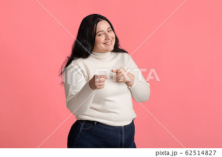 Positive Oversize Girl Pointing Fingers At Camera, Posing On Pink Background 62514827