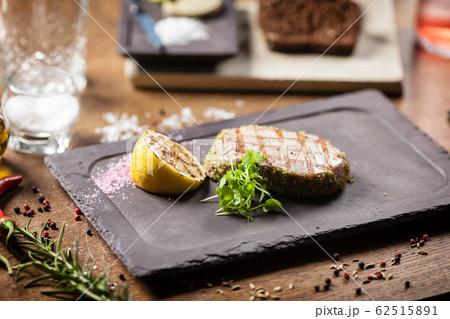 Tuna steak with panko and grilled lemon Tuna steak with panko and grilled lemon 62515891
