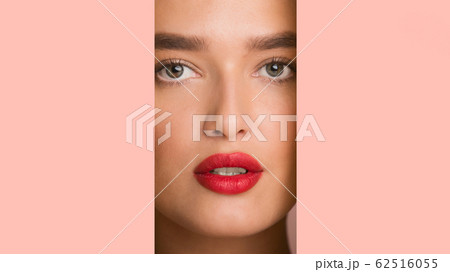 Girl with red plump lips looking through pink paper frame Girl with red plump lips looking through pink paper frame 62516055