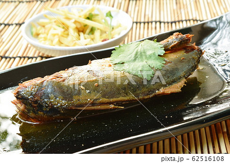 boiled salty mackerel fish in soy sauce soup on palte 62516108