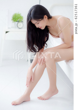 Beautiful young asian woman touch skin leg smooth with cream and lotion for hydration and smooth 62517361