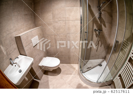 Mounted toilet bowl, sink and shower in hotel room Mounted toilet bowl, sink and shower in hotel room 62517611