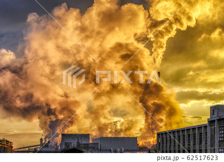 Air pollution from factory. Colorful smoke from chimneys and sunlight 62517623