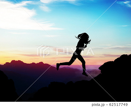 Black silhouette of woman running forward on the rock. 62517749