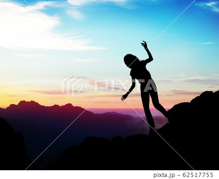Black silhouette of woman walking down of rock. Black silhouette of woman walking down of rock. 62517755