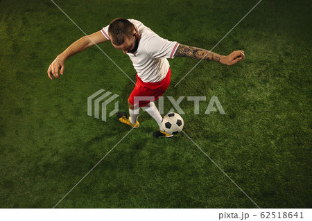 Top view of caucasian football or soccer player on green background of grass Top view of caucasian football or soccer player on green background of grass 62518641