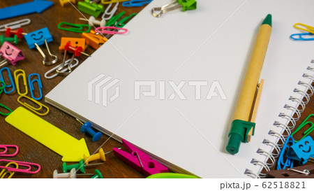 Paper notebook and stationery on wooden brown desk 62518821