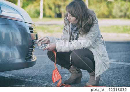 woman assembling towing hook to a broken car woman assembling towing hook to a broken car 62518836