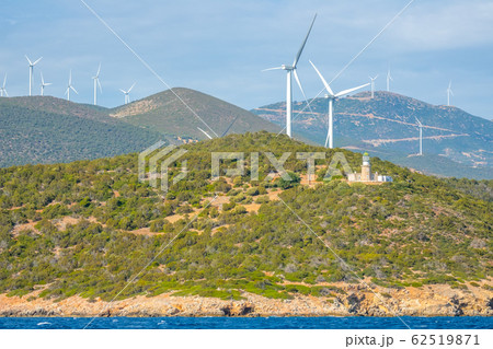 Wind Farms and Lighthouse on a Hilly Shore 62519871