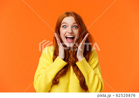 Excitement, emotions and holidays concept. Waist-up shot cheerful impressed and excited redhead woman screaming from thrill and joy, hold hands near face, open mouth and glance amazed Excitement, emotions and holidays concept. Waist-up shot cheerful impressed and excited redhead woman screaming from thrill and joy, hold hands near face, open mouth and glance amazed 62520876