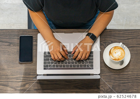 Top view photo of human hands typing laptop on table 62524678