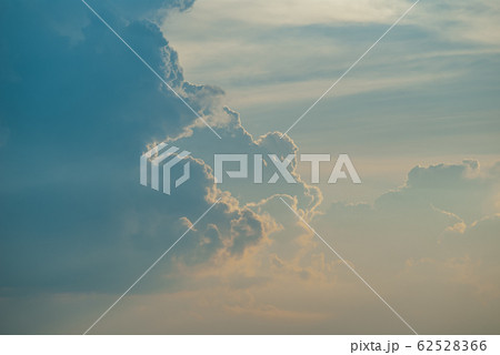 Evening sunset sky with bright rays of the sun and beautiful colorful clouds 62528366
