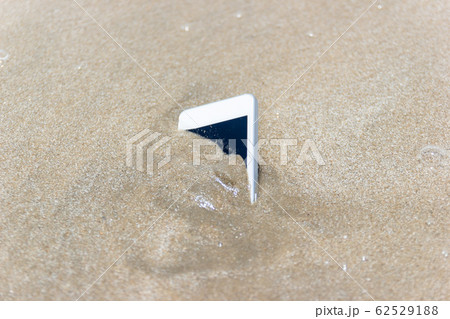 Mobile phone floated to the sea at the beach. 62529188