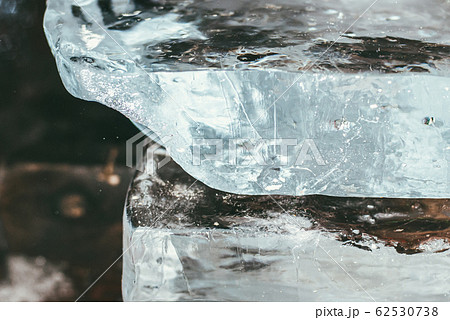 Huge blocks of clear pieces of ice one on top of the other for ice sculpture. Selective focus macro shot with shallow DOF 62530738