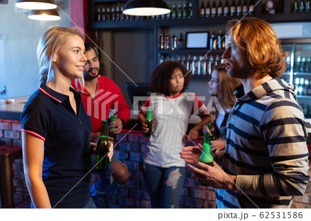 Friends discussing together while drinking 62531586