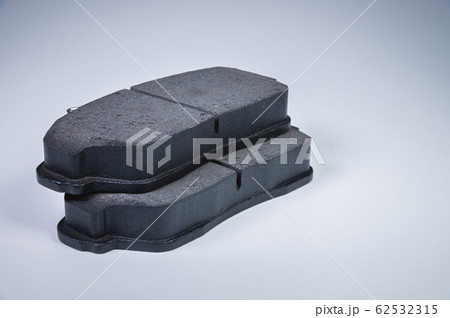 Brake pads disc brakes on a passenger car on a gray background. New spare parts maintenance service transport and repair Brake pads disc brakes on a passenger car on a gray background. New spare parts maintenance service transport and repair 62532315