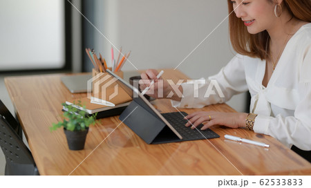 Side view of freelancer drawing on digital tablet 62533833