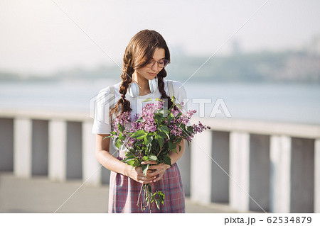 Woman with Bouquet of Flowers Outdoors in the City Street Woman with Bouquet of Flowers Outdoors in the City Street 62534879
