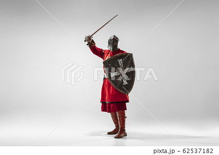 Brave armored knight fighting isolated on white studio background 62537182