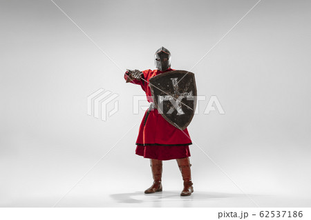 Brave armored knight fighting isolated on white studio background 62537186