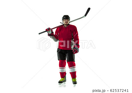 Male hockey player with the stick on ice court and white background 62537241