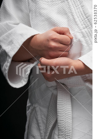 hands closeup - teenager dressed in martial arts 62538370