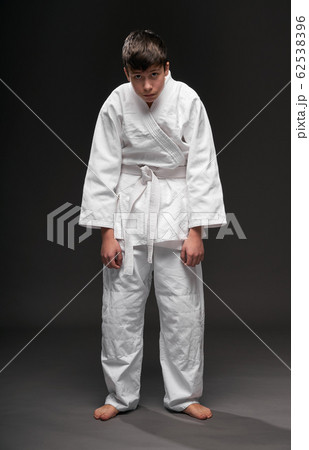 unhappy teenager dressed in martial arts clothing 62538396