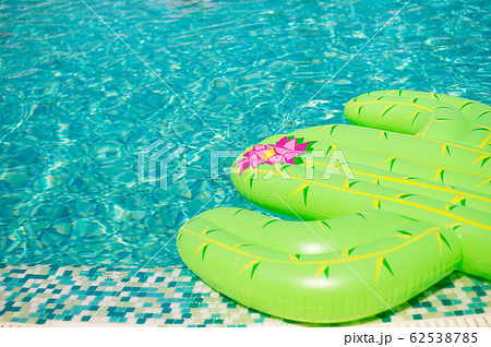 Colorful inflated cactus floating in a refreshing blue swimming pool Colorful inflated cactus floating in a refreshing blue swimming pool 62538785