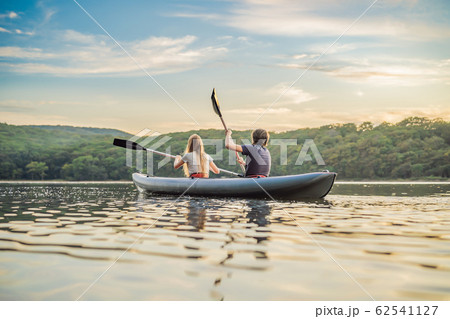 Man and woman swims on kayak in the sea on background of island. Kayaking concept.Kayaking concept 62541127