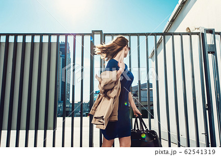 Woman in dress walking outdoors 62541319