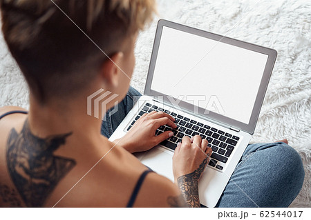 Young adult woman working on modern laptop computer Young adult woman working on modern laptop computer 62544017