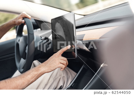 Young adult man adjusting interface system in car 62544050