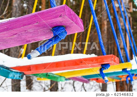 Multi-colored wooden steps in a rope park 62546832