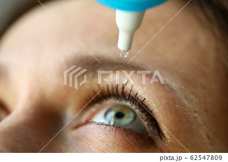 Woman drops eye drops to check vision, prevention Woman drops eye drops to check vision, prevention 62547809