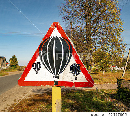 Balloons are flying - warning road sign. 62547866
