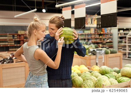 Young adult man and woman choosing watermelon Young adult man and woman choosing watermelon 62549065