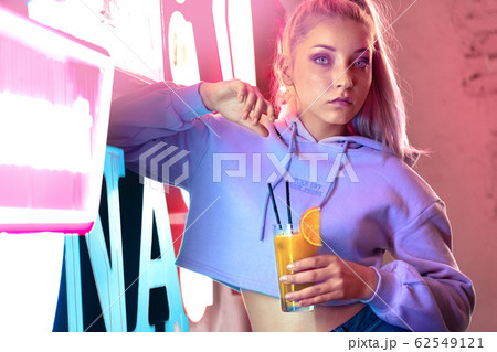Teenage girl in night club with neon light Teenage girl in night club with neon light 62549121