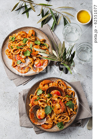 Seafood Spaghetti with seashells, prawns, squids on gray background. Italian mediterranean food 62551077