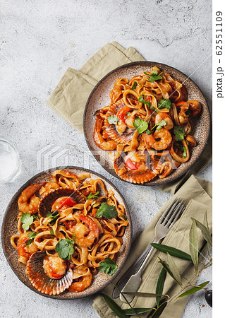 Seafood Spaghetti with seashells, prawns, squids on gray background. Italian mediterranean food Seafood Spaghetti with seashells, prawns, squids on gray background. Italian mediterranean food 62551109