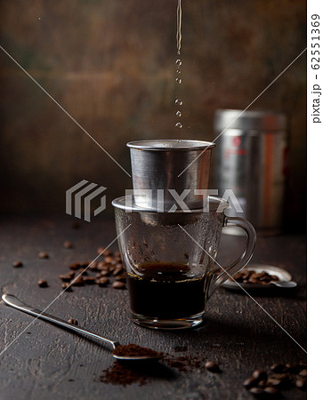 Preparation of Vietnamese coffe with aluminum cofe filer on dark background 62551369