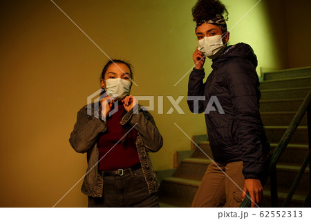 young Asian and African girl in disposable medical young Asian and African girl in disposable medical 62552313
