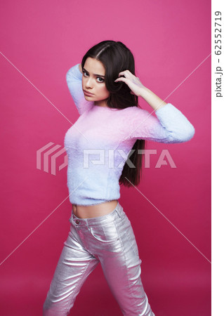 young cute girl on pink background smiling adorable emotional posing, lifestyle people concept 62552719