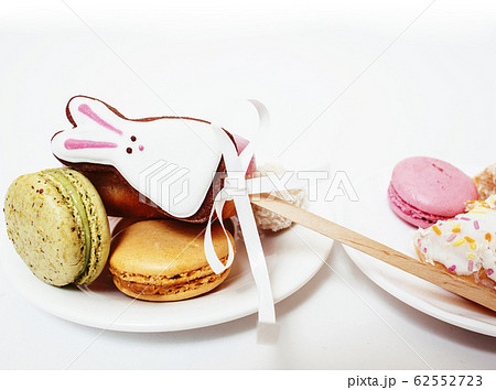 new real diet concept, question between red apple and donut with sweety candies macaroons isolated on white new real diet concept, question between red apple and donut with sweety candies macaroons isolated on white 62552723