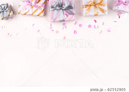 Set of gift boxes with bows and confetti on a white background. Set of gift boxes with bows and confetti on a white background. 62552905