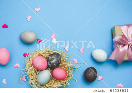 Easter eggs and nestle with eggs on blue 62553631