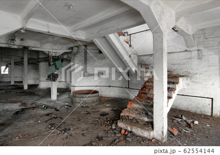 An old staircase inside an abandoned industrial An old staircase inside an abandoned industrial 62554144